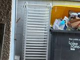 a dumpster full of garbage outside of a building
