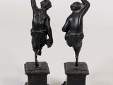 pair of antique bronze figurines of a boy and a girl