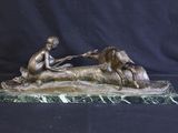 bronze statue of a boy with a horse and a dog on a marble base