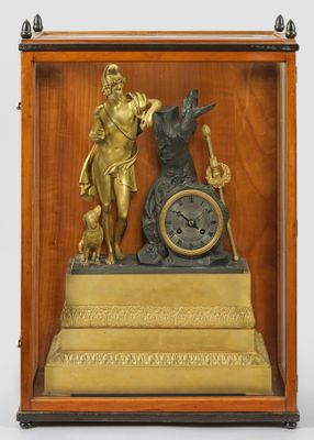 a clock that has a statue on top of it