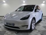 a picture of a white tesla model y in a showroom
