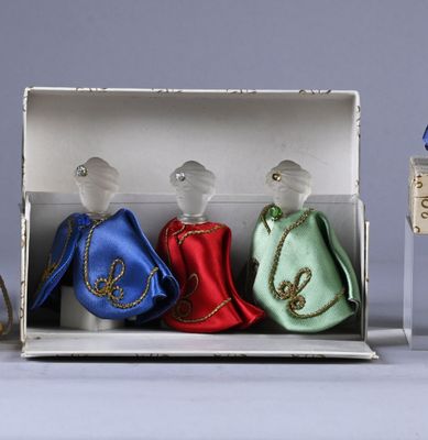 three glass figurines in a box on a table