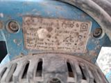 a close up of a blue machine with a number plate on it