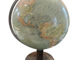 a small globe that is on a stand on a white background