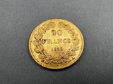 a gold coin on a black surface