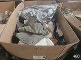 a cardboard box filled with clothes and other items