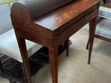 a desk with a roll top on it in a room