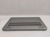 a silver laptop computer sitting on a white surface