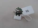 an image of a ring with green and white stones and a price tag