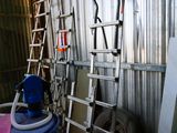 a ladder that is leaning against a wall next to a blue barrel