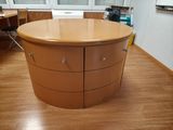 an image of a round table with drawers in a room