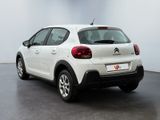 the rear of a white citrole parked in a room