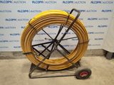 a large yellow hose on a cart with wheels