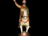 a statue of a man riding a horse with a sword