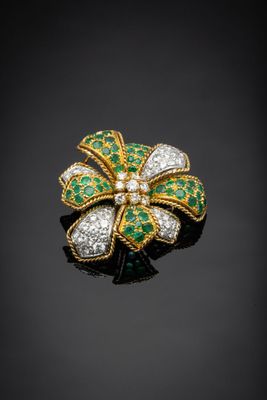 an emerald and diamond flower broochle