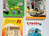 four children ' s books are lined up on a white surface