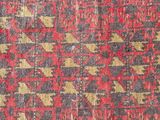 a close up of a red and black rug with a pattern on it