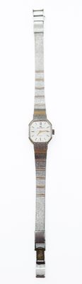 a watch that is sitting on a white surface