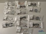 many pairs of eyeglasses in bags on the table