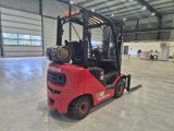a red fork truck parked inside of a building