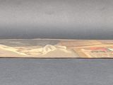 a brown bag with stamps on it sitting on a table