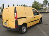 a small yellow van parked in a parking lot