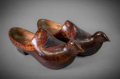 two wooden shoes that are sitting next to each other