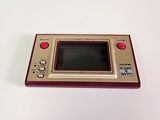 a small game console sitting on a white surface