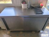 stainless steel counter top in a kitchen with a tablet on it
