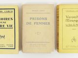 three books sitting on top of each other on a white surface