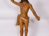 wooden statue of jesus on a cross with a cloth draped around his waist