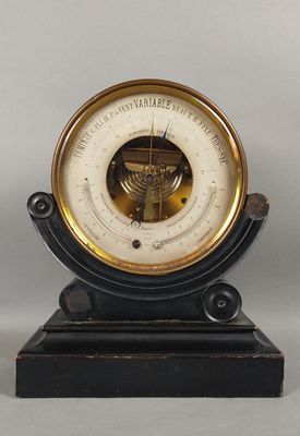 a black and gold clock with a barometer on it