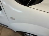 a white van with a black window and a black door handle