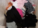 a pile of clothes in a bag on the floor