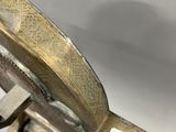 a close up of a metal object on a white surface