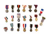 an assortment of medals and medals on a white surface