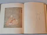 an open book with a picture of a woman sitting on the floor