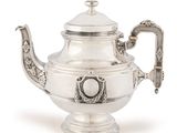 an antique silver tea pot with a handle on a white background