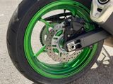 a close up of a motorcycle tire with green rims