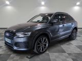 a grey audi suv parked on a checkered floor in a showroom