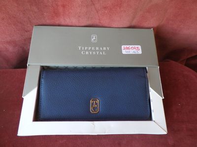 a blue purse in a box on a red couch