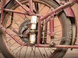 a close up view of a red bicycle with a chain attached to it