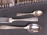 a lot of silver spoons and forks on the table