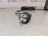a close up of a plug on a table with a box in the background