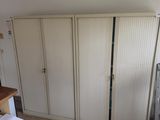 a kitchen with a stove, refrigerator, and a refrigerator freezer in it