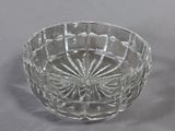 two clear glass bowls with a flower design on them on a gray surface