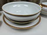 a lot of plates and bowls sitting on a table