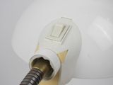 an image of a white light bulb with a brown cord