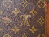 a close up of a brown and tan louis vuitton bag
