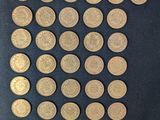 a lot of gold coins on a black cloth